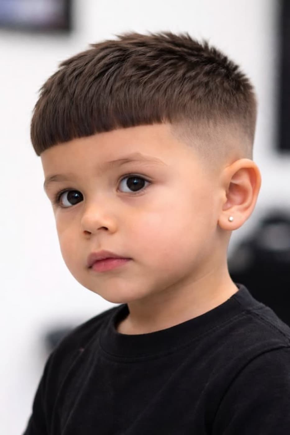 A young boy with a fresh textured crop and skin fade