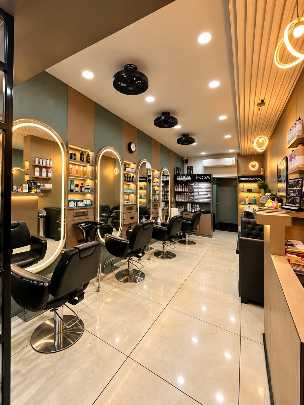The Mordez salon floor with oval LED mirrors and black styling chairs